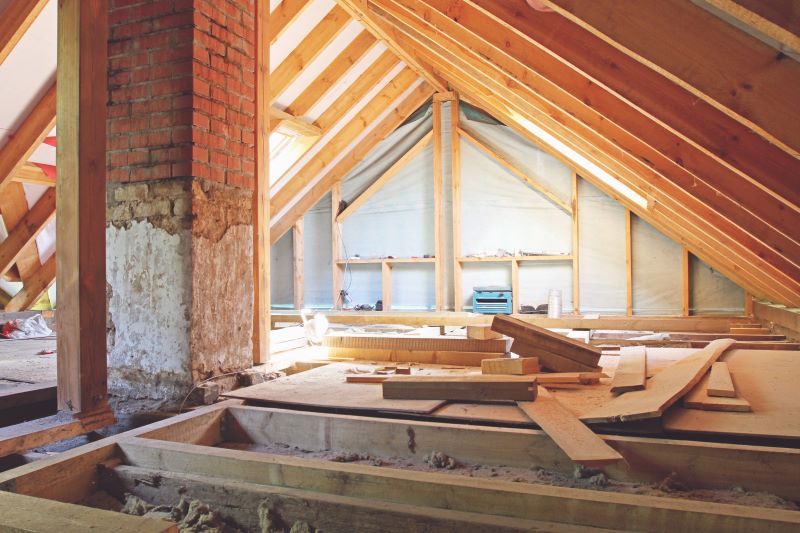 Unfinished attic with a thin layer of cellulose insulation spread on the ground.