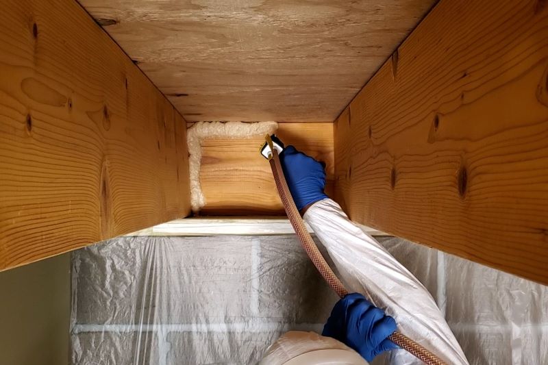 Insulating rim joist with spray foam sealant