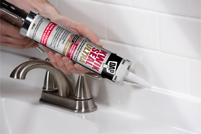 Kwik Seal Ultra sealant being applied to bathroom counter edge.