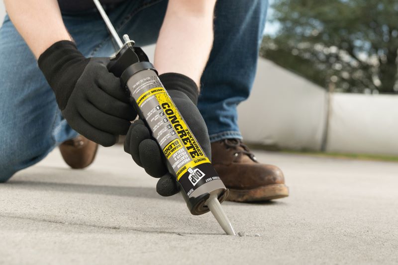 Concrete filler being applied to crack in the ground